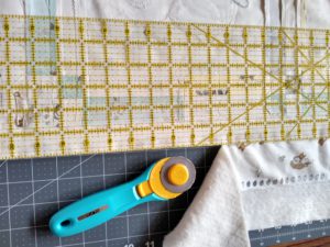 Trimming Fabric Quilt with Ruler and Rotary cutter