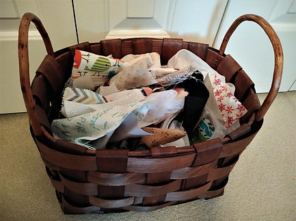 Wooden basket filled with fabric scraps