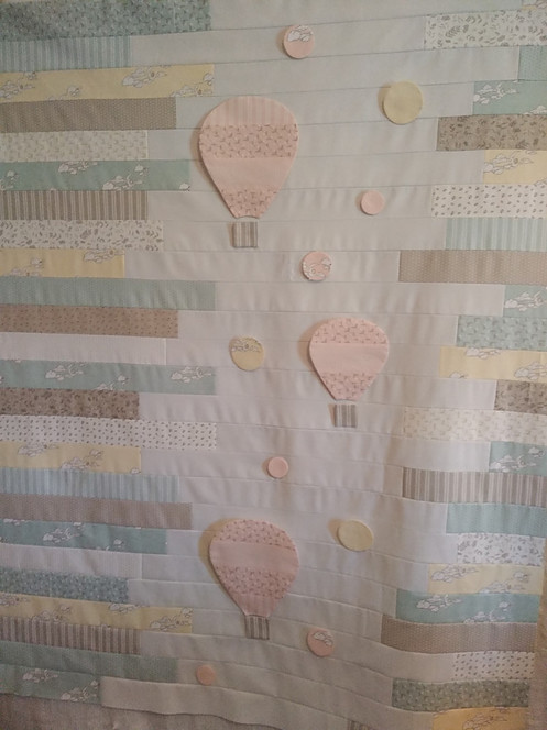 Quilt top made from jelly roll strips and applique hot air ballons and bubbles