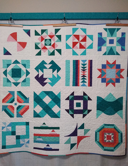 Summer Sampler 2020 quilt hanging from top of new design wall