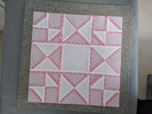 Underside of quilt block showing seams pressed open