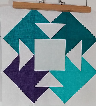 Blue, green and white fabric sewn together to form a quilt block