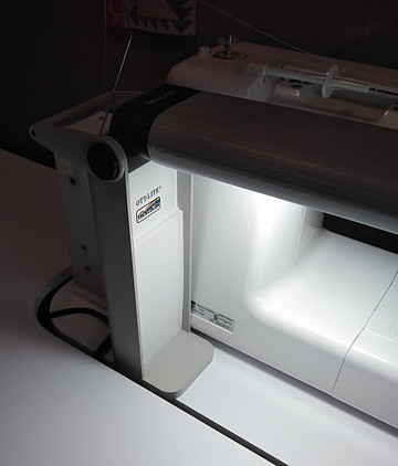 Ott desk lamp placed behind sewing machine