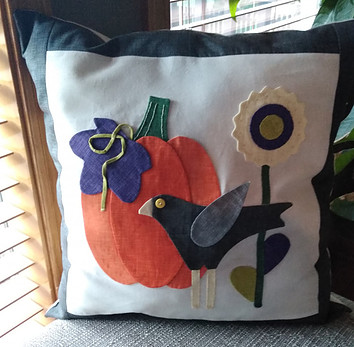 Applique pillow made from Lori Holt's Autumn Love pumpkin, crow and flower templates