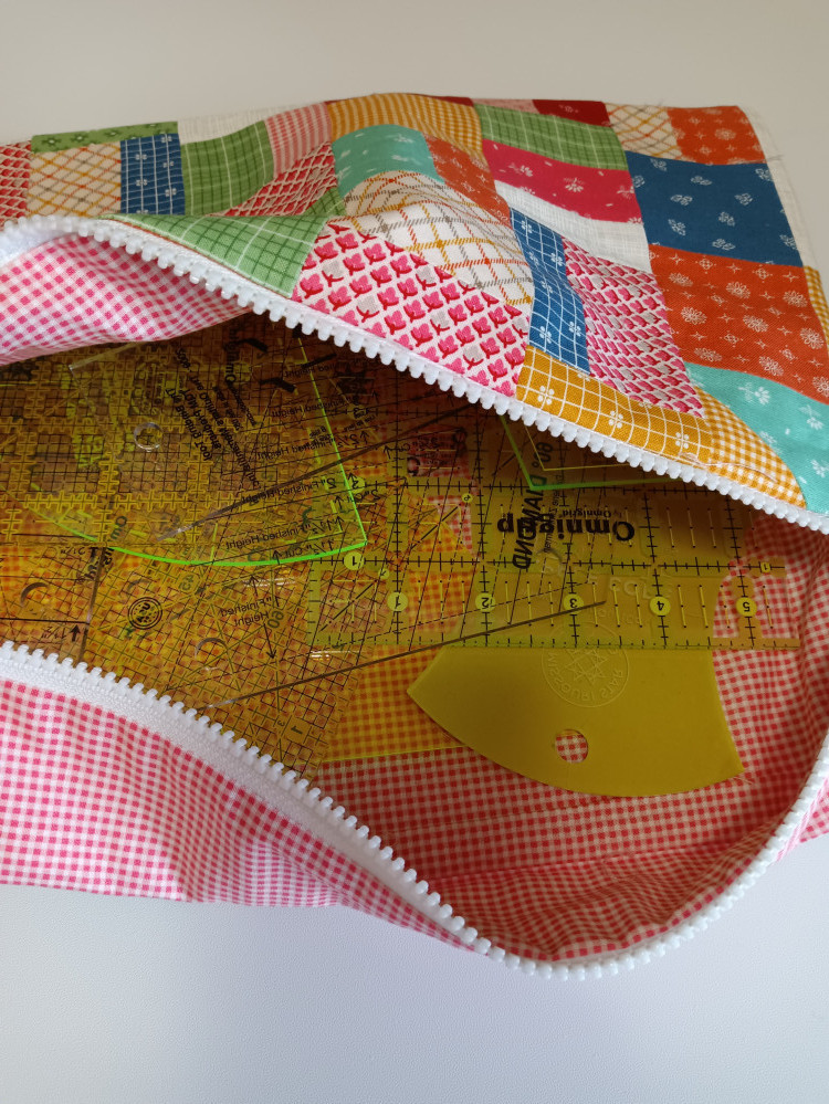 Fabric project bag filled with quilting rulers