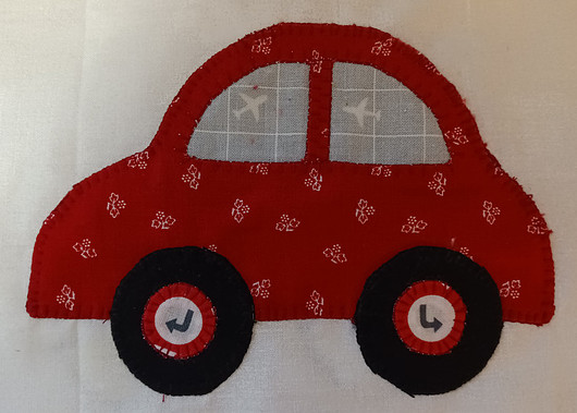 Red fabric car applique with black wheels