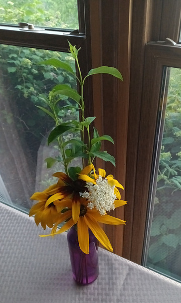 Wildflower arrangement in purple glass vase