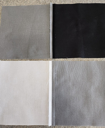 5' squares of black, white and gray fabric sewn in pairs with seams pressed open.