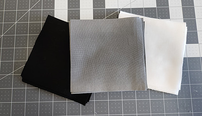 Black, white and gray 5' squares of fabric
