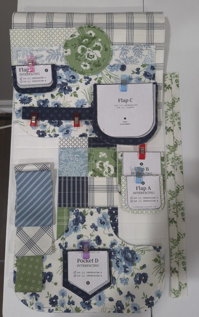 Quilt fabric (Nantucket Summer by Camille Roskelley) organized into stacks in preparation for sewing a sofa style organizer