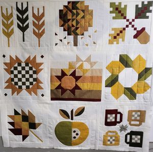 Quilt top made from Sweater Weather 2024 quilt blocks. Fabrics in autumnal colors in Essex linen by Robert Kauffman