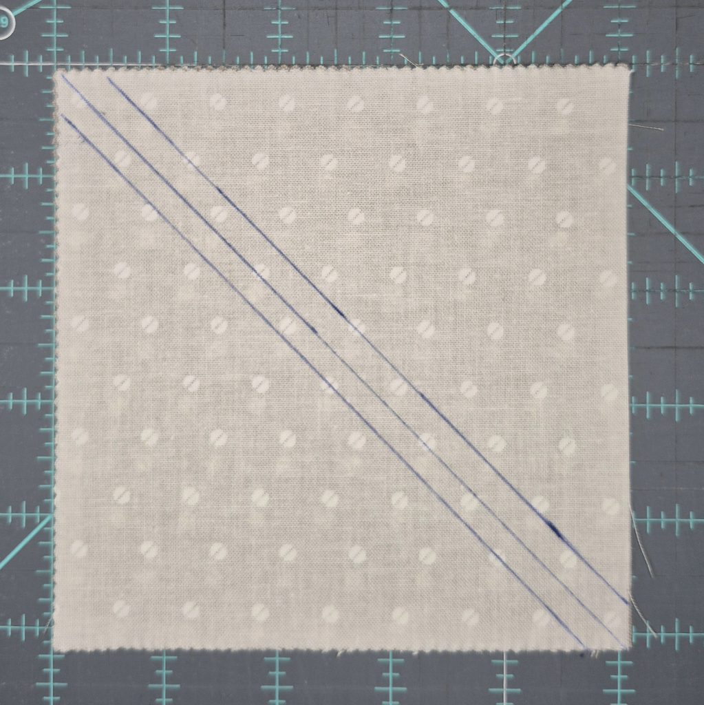 Fabric with sewing lines and center cut line.