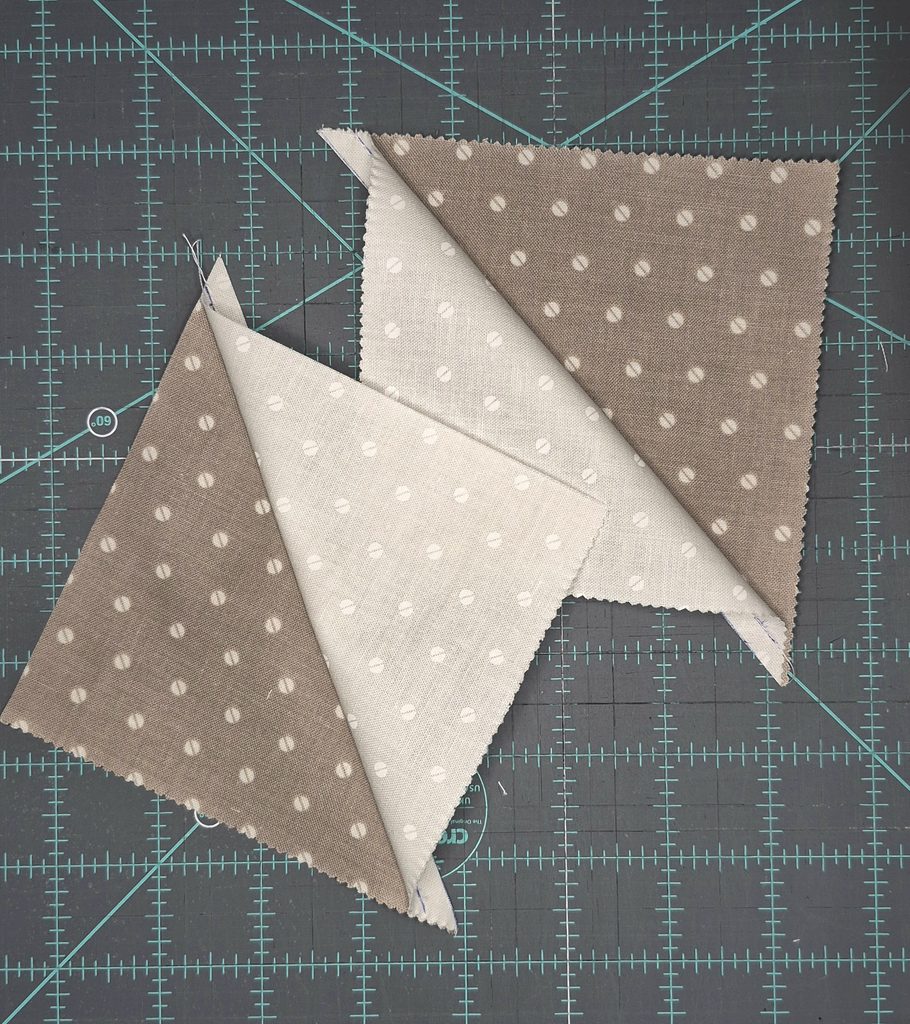 Two triangles opened up to recreate a square shape using two different fabrics.