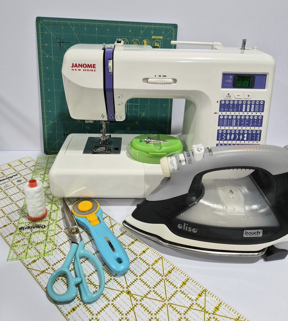 quilting tools: sewing machine, iron thread, ruler and cutting tools