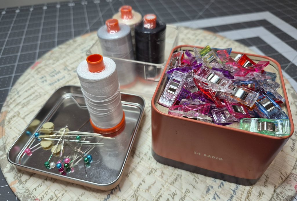 grouping of quilting tools: pins, clips and thread